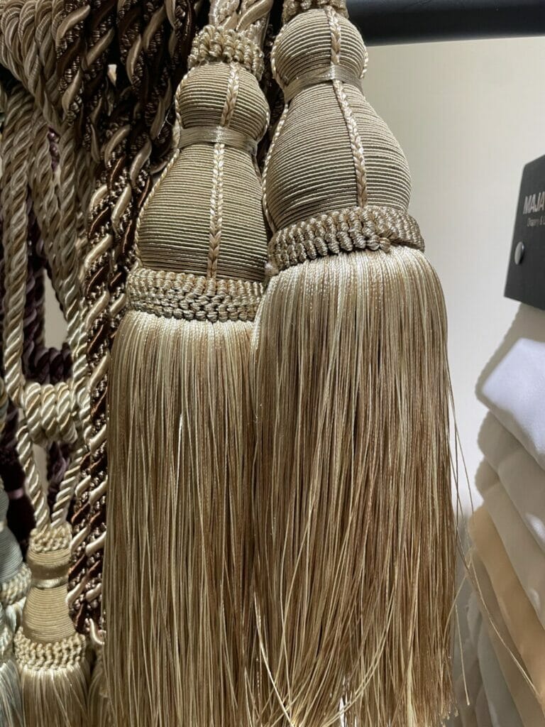 Tassels hanging on a rack in a store. Keywords: tassels, rack/store.
