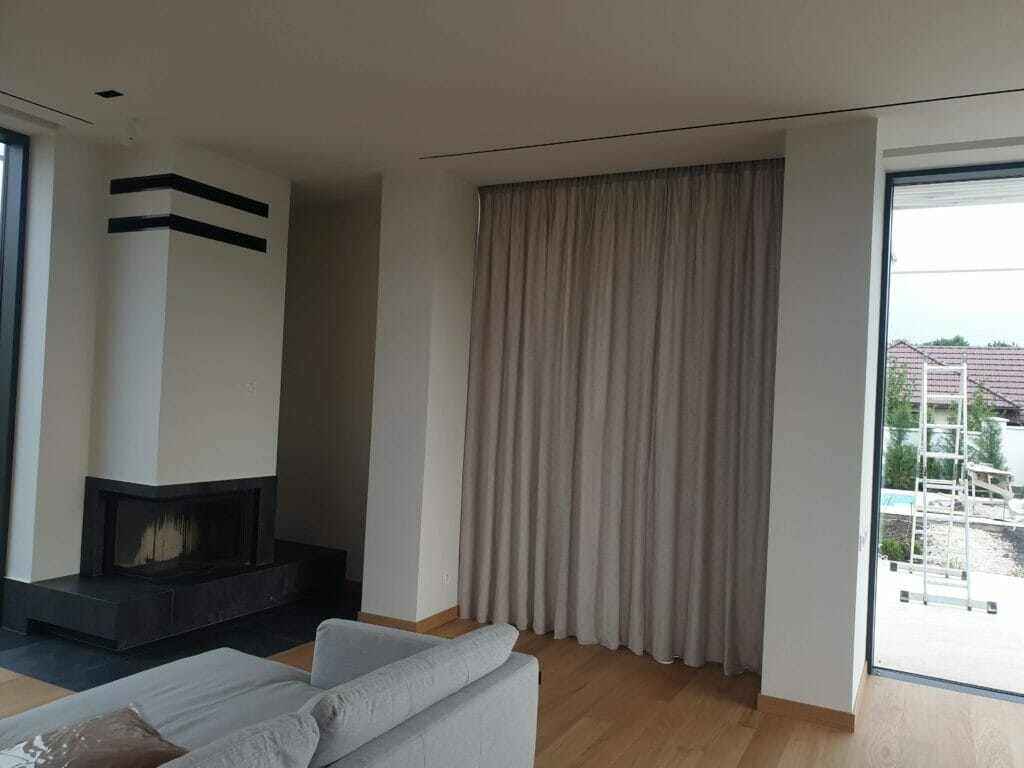 A living room with a fireplace and sliding glass doors.